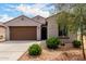 Charming home with a brown garage door and desert landscaping, offering great curb appeal at 5013 S 112Th Ave, Tolleson, AZ 85353