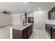 Modern kitchen with a large island featuring a granite countertop and stainless steel appliances at 5013 S 112Th Ave, Tolleson, AZ 85353