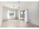 Bright living room with tile flooring, pendant lighting, sheer curtains and sliding glass door at 5013 S 112Th Ave, Tolleson, AZ 85353