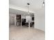 Open-concept living room flows into kitchen with island, wood accents, tile floors, and ample space at 5013 S 112Th Ave, Tolleson, AZ 85353