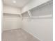Spacious walk-in closet with ample shelving and neutral carpet flooring, perfect for organization at 5013 S 112Th Ave, Tolleson, AZ 85353