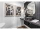 Stylish bathroom with dark vanity, marble sink, and geometric tile at 6712 E Pershing Ave, Scottsdale, AZ 85254