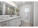 Clean bathroom with white cabinets and a window at 6712 E Pershing Ave, Scottsdale, AZ 85254