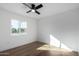 Well-lit bedroom featuring wood floors and a window at 6712 E Pershing Ave, Scottsdale, AZ 85254
