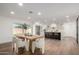 Modern dining area with a large wooden table and white chairs at 6712 E Pershing Ave, Scottsdale, AZ 85254