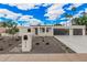 Stunning modern home featuring a well-manicured front yard, clean lines, and a spacious driveway leading to a two-car garage at 6712 E Pershing Ave, Scottsdale, AZ 85254