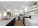 Modern kitchen with white cabinets, quartz countertops, and stainless steel appliances at 6712 E Pershing Ave, Scottsdale, AZ 85254