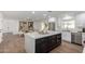 Open concept kitchen with island, hardwood floors, and dining area at 6712 E Pershing Ave, Scottsdale, AZ 85254