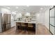 Modern kitchen with white cabinets, a large island, and stainless steel appliances at 6712 E Pershing Ave, Scottsdale, AZ 85254