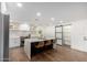 Stylish kitchen with white cabinets, island with seating and a pantry at 6712 E Pershing Ave, Scottsdale, AZ 85254