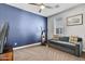 Bedroom featuring a comfortable couch, exercise bike, and modern TV at 6850 E Mcdowell Rd # 72, Scottsdale, AZ 85257