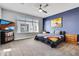 Comfortable bedroom with a colorful bedspread, ample natural light, and modern entertainment setup at 6850 E Mcdowell Rd # 72, Scottsdale, AZ 85257