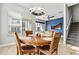 Charming dining area with a wooden table, modern lighting, and a view into the living room at 6850 E Mcdowell Rd # 72, Scottsdale, AZ 85257