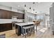 Modern kitchen featuring dark cabinets, stainless steel appliances, and a large island with seating at 6850 E Mcdowell Rd # 72, Scottsdale, AZ 85257