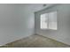 Simple bedroom with window and carpet flooring at 7037 W Pontiac Dr, Glendale, AZ 85308