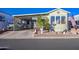 Inviting manufactured home exterior, featuring a covered carport and well-maintained landscaping at 7750 E Broadway Rd # 770, Mesa, AZ 85208