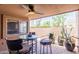 Covered patio featuring a ceiling fan and desert views with a glass table set at 7770 E Camelback Rd # 16, Scottsdale, AZ 85251