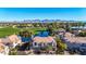 Stunning aerial view of a townhouse overlooking a lush green golf course and sparkling lake with mountain views at 8989 N Gainey Center Dr # 222, Scottsdale, AZ 85258