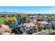 Breathtaking aerial perspective of a townhouse neighborhood by a golf course, a serene lake, and mountain backdrop at 8989 N Gainey Center Dr # 222, Scottsdale, AZ 85258