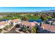 Scenic aerial shot of a townhouse community nestled alongside a picturesque golf course with a tranquil lake at 8989 N Gainey Center Dr # 222, Scottsdale, AZ 85258