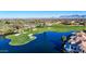 Expansive aerial view showcasing a lush golf course and a tranquil lake in a vibrant residential neighborhood at 8989 N Gainey Center Dr # 222, Scottsdale, AZ 85258