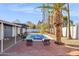Spacious backyard with brick patio, pool, and lush landscaping at 9412 N 33Rd Way, Phoenix, AZ 85028