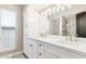 Double vanity bathroom with quartz countertops and updated lighting at 9412 N 33Rd Way, Phoenix, AZ 85028