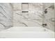 Elegant bathroom with marble tile and a soaking tub at 9412 N 33Rd Way, Phoenix, AZ 85028