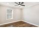 Bright bedroom with wood-look floors and a window at 9412 N 33Rd Way, Phoenix, AZ 85028