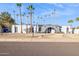 Mid-century modern home with gray exterior and palm trees at 9412 N 33Rd Way, Phoenix, AZ 85028