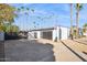 Modern home with gray exterior, black gate, and palm trees at 9412 N 33Rd Way, Phoenix, AZ 85028