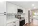 Modern kitchen with stainless steel appliances and white cabinets at 9412 N 33Rd Way, Phoenix, AZ 85028