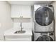 Laundry room with white cabinets, quartz countertop and Whirlpool washer/dryer at 9412 N 33Rd Way, Phoenix, AZ 85028