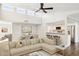 Open living room features hardwood floors, a sectional sofa, and a view into the kitchen at 9412 N 33Rd Way, Phoenix, AZ 85028