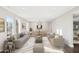 Bright living room with hardwood floors, ample seating, and a view of dining area at 9412 N 33Rd Way, Phoenix, AZ 85028