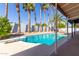 Inviting kidney-shaped pool with diving board, surrounded by a lush, desert landscape at 9412 N 33Rd Way, Phoenix, AZ 85028