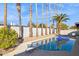 Inviting backyard pool with diving board, surrounded by palm trees at 9412 N 33Rd Way, Phoenix, AZ 85028
