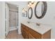 Bathroom with double vanity, oval mirrors, and shower at 10245 W Jessie Ln, Peoria, AZ 85383