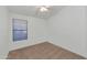 This bedroom has neutral carpet, a window with blinds, and a ceiling fan at 10245 W Jessie Ln, Peoria, AZ 85383