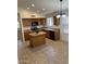 Well-lit kitchen with wooden cabinets, an island and modern appliances at 10245 W Jessie Ln, Peoria, AZ 85383