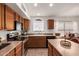 A kitchen featuring wooden cabinetry, a kitchen island, and modern appliances at 10245 W Jessie Ln, Peoria, AZ 85383