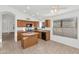 Kitchen with wood cabinets, an island, and tile floor at 10245 W Jessie Ln, Peoria, AZ 85383