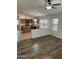 A kitchen flows into the living room in this open concept floorplan with hardwood floors at 10245 W Jessie Ln, Peoria, AZ 85383