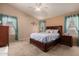 Cozy main bedroom featuring a ceiling fan, carpet flooring and ensuite bathroom at 10245 W Jessie Ln, Peoria, AZ 85383