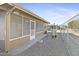 Home exterior showcasing a screened patio, grill, and fenced yard at 10537 W Prairie Hills Cir, Sun City, AZ 85351