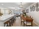 Bright dining area with hardwood floors and kitchen bar at 10537 W Prairie Hills Cir, Sun City, AZ 85351