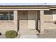 Front entry with brick columns, sunburst door and welcome mat at 10537 W Prairie Hills Cir, Sun City, AZ 85351