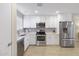 Modern kitchen with white cabinets and stainless steel appliances at 10537 W Prairie Hills Cir, Sun City, AZ 85351