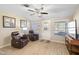 Relaxing living room with two leather recliners and wood-look tile floors at 10537 W Prairie Hills Cir, Sun City, AZ 85351