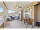 Relaxing screened patio with seating and a ceiling fan at 10537 W Prairie Hills Cir, Sun City, AZ 85351